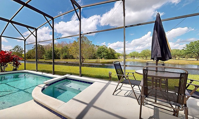 Trafalgar Village Casa | Water view retreat with lanai, heated pool, pool spa, game room, & AC