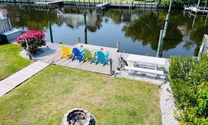 Colington Harbour Casa | Waterfront! Game Room, Hot Tub, Kayaks, SUPSs, Fire Pit, Theater Room, Dogs OK