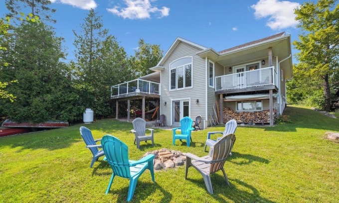 Miller Lake Cabaña | Watersedge: 4BR Miller Lake cottage with dock, firepit, decks, spacious interiors, rec room & foosball.