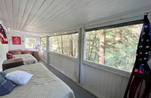 Greene Cabaña | Rustic cottage surrounded by trees, overlooking a creek.