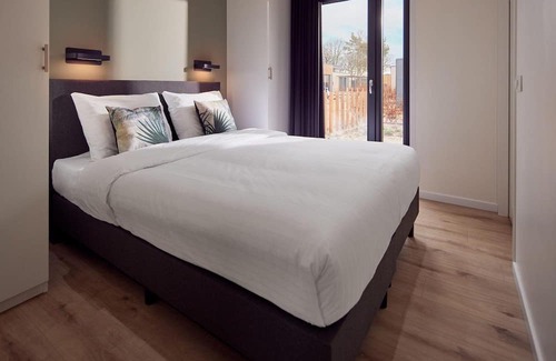 Lattrop Casa | The Amalia is a four-person holiday home and has an attractive homely living room with an open kitchen, two bedrooms and a spacious outdoor area.