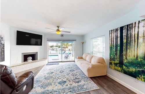 Capri Isle Casa | Renovated, waterfront townhome with pool & dock - walk to the beach