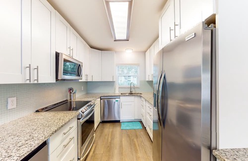 Capri Isle Casa | Renovated, waterfront townhome with pool & dock - walk to the beach