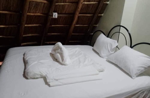 Western Region Otro | White Cat Farm Hut Inn is nestled on the outskirts of a quaint African village