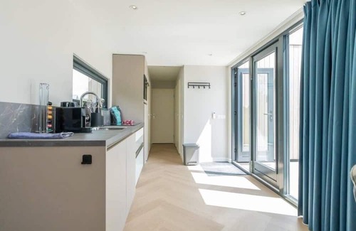 Scharendijke Casa | Welcome to Muralt 111, a modern chalet with everything for a carefree stay. Enjoy the cozy living ro