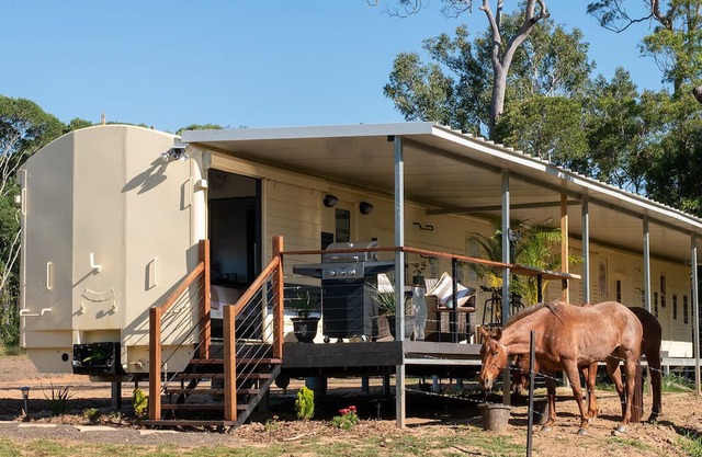 Train Carriage in peaceful surrounds with mountain views on a farm.