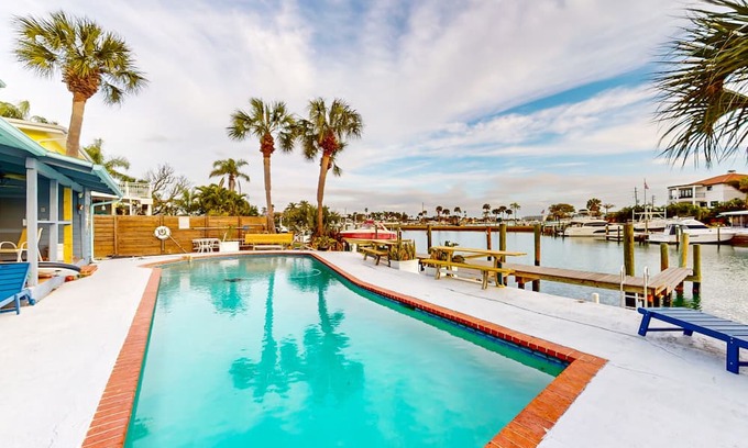 Capri Isle Casa | Renovated, waterfront townhome with pool & dock - walk to the beach